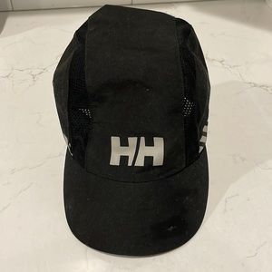 Black Helly Hansen cap with a small pocket and mesh on the sides.